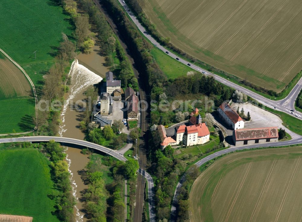 Aerial image Bad Friedrichshall - Castle Heuchlingen in the Duttenberg part of Bad Friedrichshall in the state of Baden-Wuerttemberg. The agriculturally used and state owned farm was originally built in the 12th century and redesigned as a Baroque-style castle in the 18th century. Main tenant since 1900 is the Suedzucker AG (sugar producer). It now consists of offices and appartments. The compound is located on a railway track, surrounded by fields