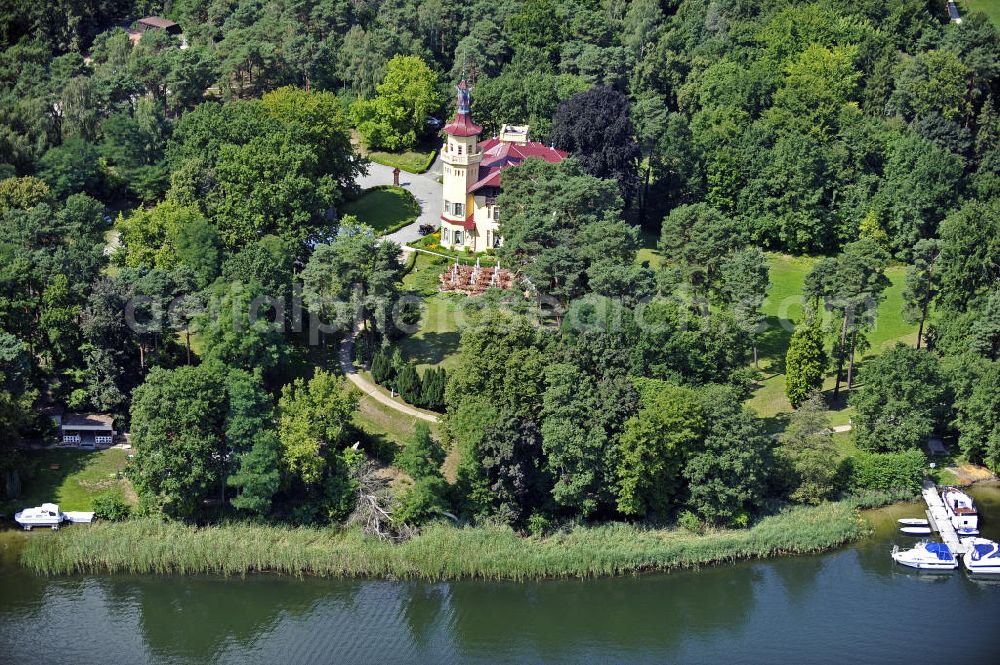 Aerial image Storkow - Blick auf das 5-Sterne-Hotel bei Hubertushöhe am Storkower See. Das Jagdschloss wurde im Landhausstil erbaut und zeigt verschiedene Drachenelemente. Das Hotel bietet 23 luxuriöse Zimmer und Suiten an. View of the five-star hotel Hubertushoehe on Lake Storkow. The hunting lodge was built in the country house style and shows several dragon elements. The hotel offers 23 luxurious rooms and suites.