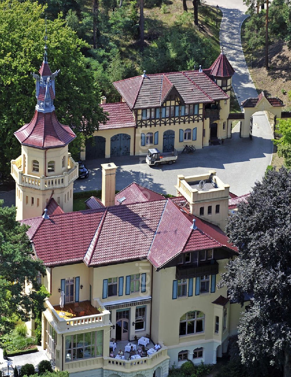 Aerial image Storkow - Blick auf das 5-Sterne-Hotel bei Hubertushöhe am Storkower See. Das Jagdschloss wurde im Landhausstil erbaut und zeigt verschiedene Drachenelemente. Das Hotel bietet 23 luxuriöse Zimmer und Suiten an. View of the five-star hotel Hubertushoehe on Lake Storkow. The hunting lodge was built in the country house style and shows several dragon elements. The hotel offers 23 luxurious rooms and suites.