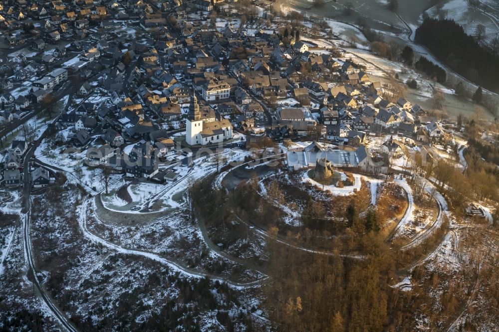 Aerial photograph Meschede - Winter landscape with view of the Eversberg Castel and Eversberg church covered with snow in Meschede in North Rhine-Westphalia