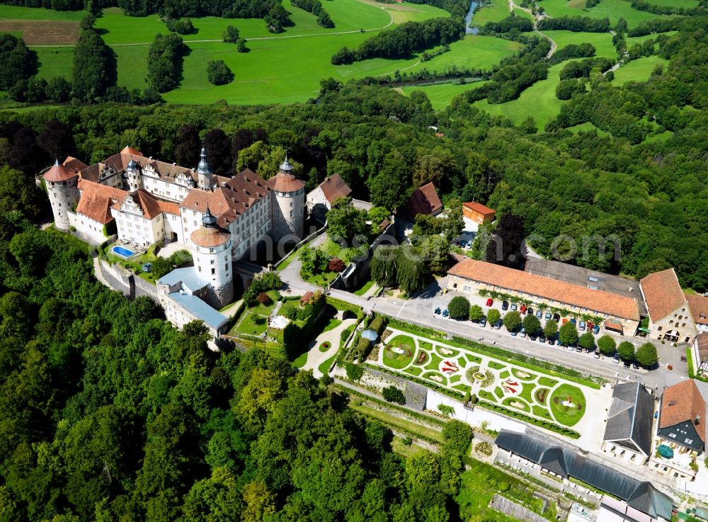 Aerial photograph Langenburg - Castle Langenburg in Langenburg in the state of Baden-Württemberg. The castle is located on a mountain high above the Valley of the Jagst. It is the residence of the family Hohenlohe-Langenburg. Originally built as a fortress it was redesigned in the baroque style including a distinct garden and park amidst the forest. Publicly open are the museum, café, the German Automobile Museum as well as the main hall for concerts. The compound is also the site of the Gartentage a gardening festival and exhibition