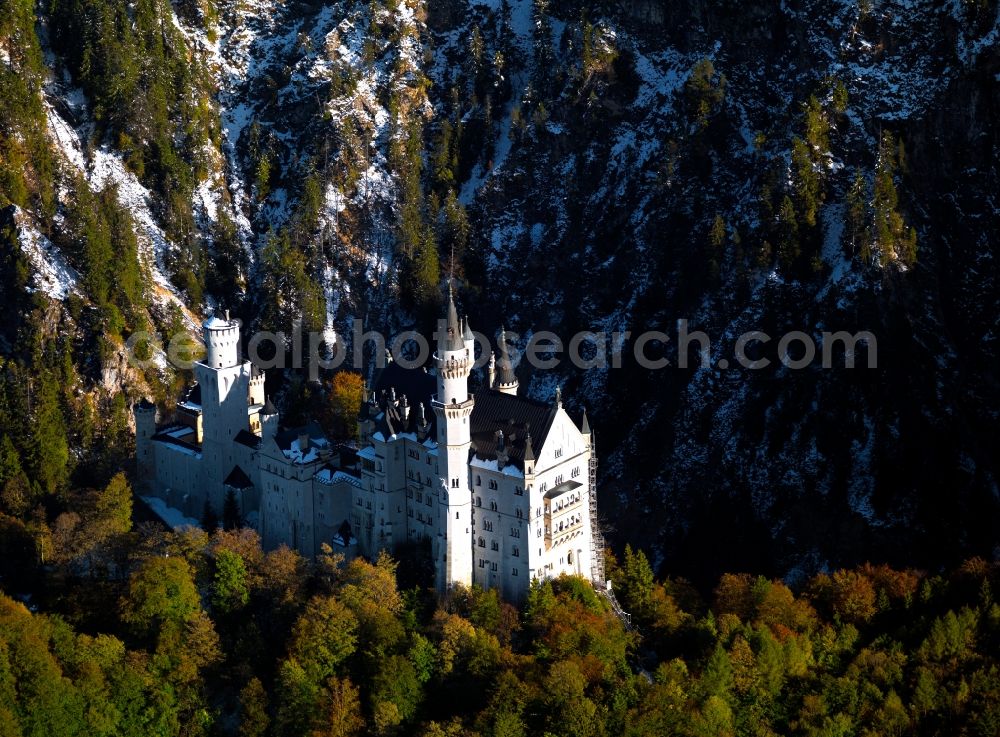 Hohenschwangau from the bird's eye view: Neuschwanstein Castle in Hohenschwangau in the state of Bavaria. The castle was built in the 19th century for Ludwig II of Bavaria. Today, the owner is the free state and the castle is one of the most famous landmarks in Germany and a beloved tourism site. Built in a historism style, it is also called a fairy tale castle