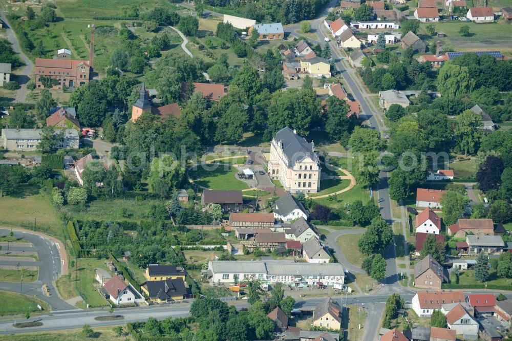 Aerial photograph Nauen - View of the Ribbeck part of the town of Nauen in the state of Brandenburg. The town is located in the county district of Havelland. Ribbeck is known for the castle from the 19th century, located in its centre. The historic building is surrounded by a park