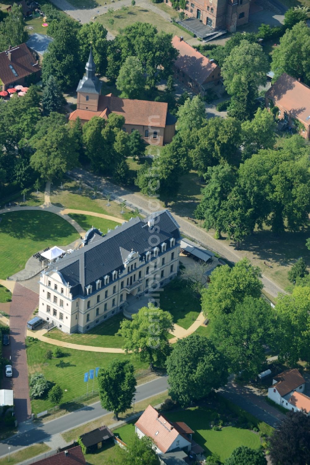 Aerial photograph Nauen - View of the Ribbeck part of the town of Nauen in the state of Brandenburg. The town is located in the county district of Havelland. Ribbeck is known for the castle from the 19th century, located in its centre. The historic building is surrounded by a park