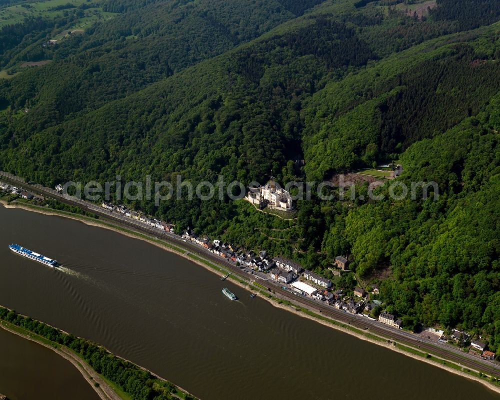 Koblenz from the bird's eye view: Stolzenfels Castle in Koblenz in the state Rhineland-Palatinate. The castle is located on the riverbank of the river Rhine, opposite Lahnstein. The former fortress was rebuilt as a castle in the Rhine romantic style. Railway tracks run in front of it