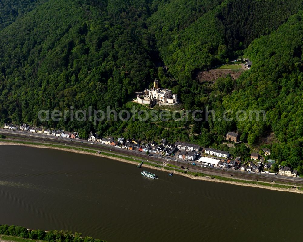 Aerial photograph Koblenz - Stolzenfels Castle in Koblenz in the state Rhineland-Palatinate. The castle is located on the riverbank of the river Rhine, opposite Lahnstein. The former fortress was rebuilt as a castle in the Rhine romantic style. Railway tracks run in front of it