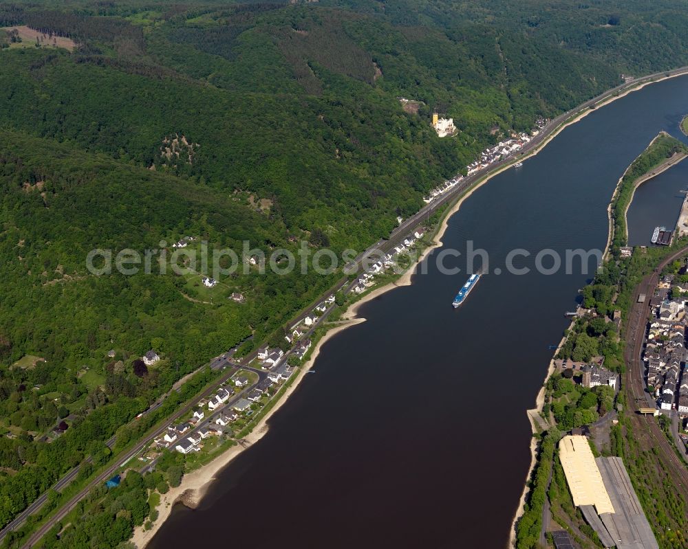 Aerial photograph Koblenz - Stolzenfels Castle and course of the river Rhine in Koblenz in the state Rhineland-Palatinate. The castle is located on the riverbank of the river Rhine, opposite Lahnstein. The former fortress was rebuilt as a castle in the Rhine romantic style. Railway tracks run in front of it