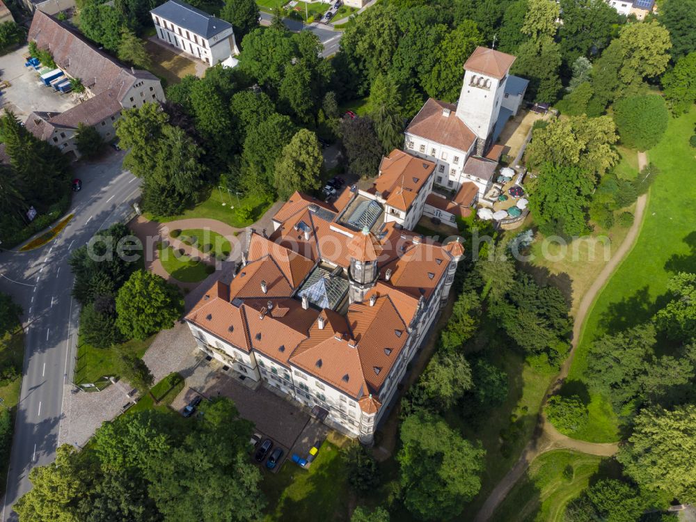 Waldenburg from above - Castle Waldenburg in Waldenburg in the state of Saxony. The castle with its castle keep is surrounded by forest and located on a hill in the Southeast of Waldenburg