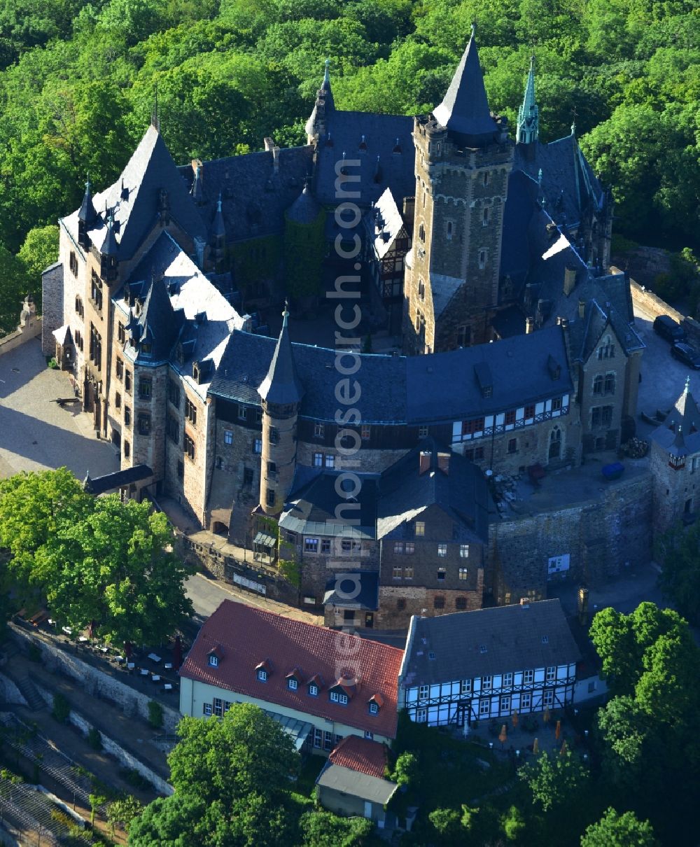 Aerial photograph Wernigerode - View of the Wernigerode Castle in Wernigerode in the state Saxony-Anhalt. The Wernigerode Castle is located in the Harz mountains. Today it houses a popular museum