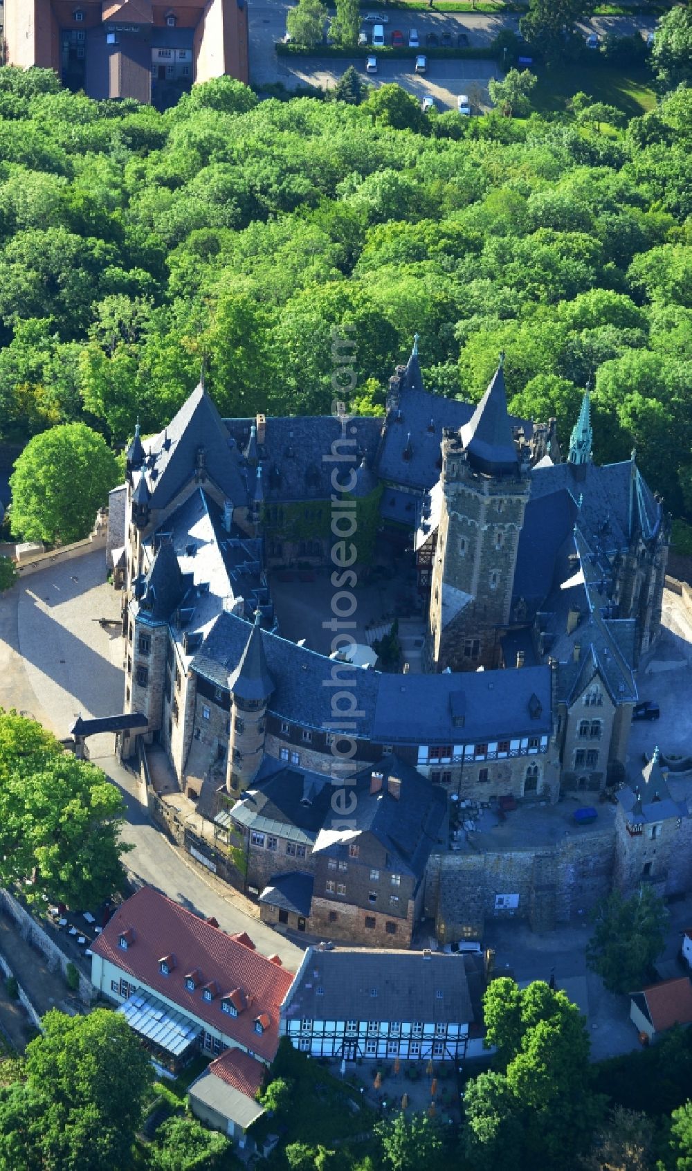 Wernigerode from above - View of the Wernigerode Castle in Wernigerode in the state Saxony-Anhalt. The Wernigerode Castle is located in the Harz mountains. Today it houses a popular museum