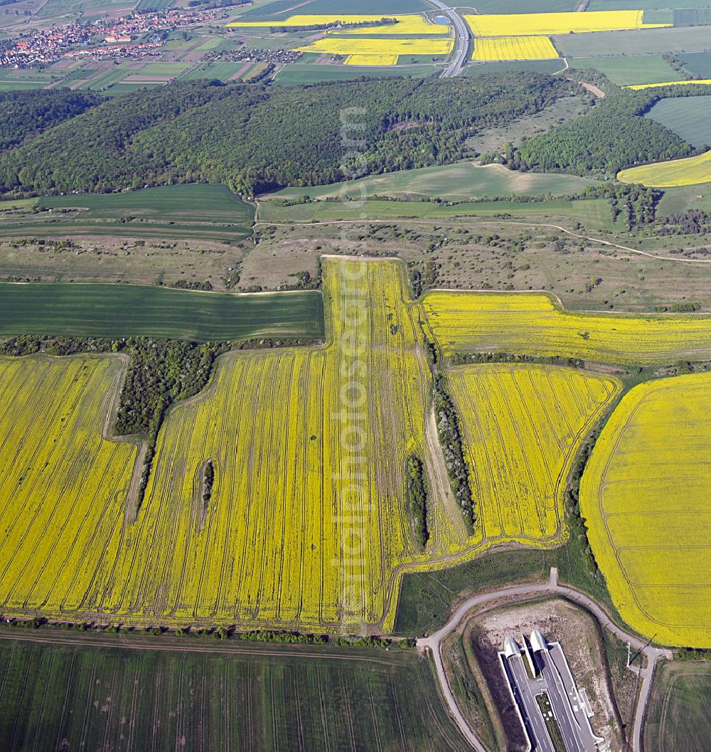 Oberheldrungen from the bird's eye view: Blick auf den mit Raps- Feldern umgebenen Schmücketunnel im Bereich der neuen Trassenführung der Autobahn A71 südwestlich von Harras / Oberheldrungen in Thüringen nach der Verkehrsfreigabe. SCHÜßLER PLAN, BARESEL; KUNZ Bau; Kirchner Bau in Projektdurchführung durch die DEGES Deutsche Einheit Fernstraßenplanungs- und -bau GmbH.View of the Schmücketunnel in the new route of the A71 motorway southwest of Harass / Oberheldrungen in Thuringia after the opening to traffic.