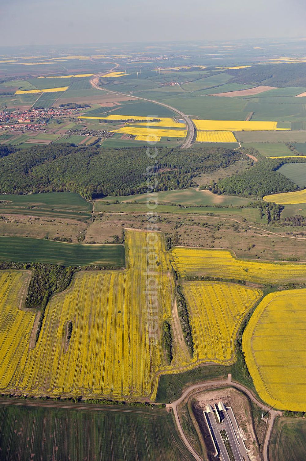 Aerial image Oberheldrungen - Blick auf den mit Raps- Feldern umgebenen Schmücketunnel im Bereich der neuen Trassenführung der Autobahn A71 südwestlich von Harras / Oberheldrungen in Thüringen nach der Verkehrsfreigabe. SCHÜßLER PLAN, BARESEL; KUNZ Bau; Kirchner Bau in Projektdurchführung durch die DEGES Deutsche Einheit Fernstraßenplanungs- und -bau GmbH.View of the Schmücketunnel in the new route of the A71 motorway southwest of Harass / Oberheldrungen in Thuringia after the opening to traffic.