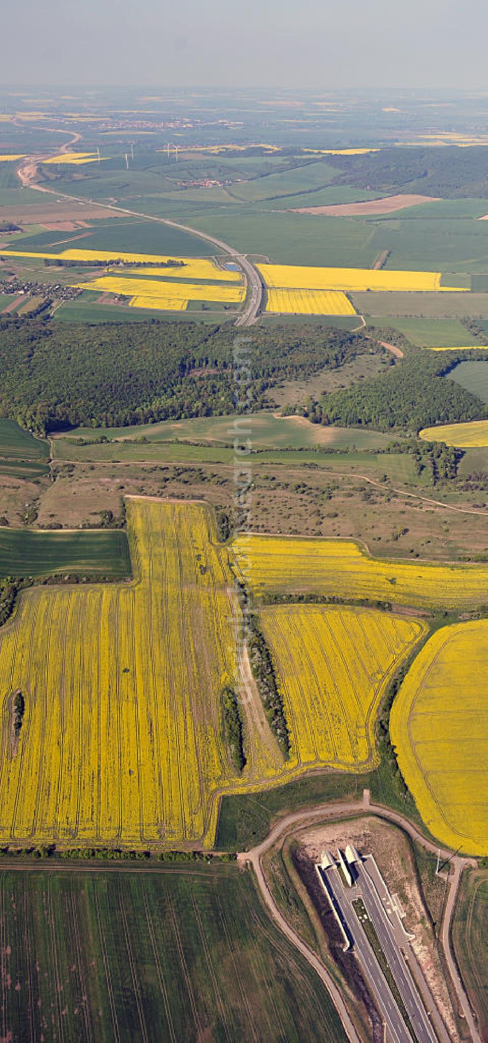 Aerial photograph Oberheldrungen - Blick auf den mit Raps- Feldern umgebenen Schmücketunnel im Bereich der neuen Trassenführung der Autobahn A71 südwestlich von Harras / Oberheldrungen in Thüringen nach der Verkehrsfreigabe. SCHÜßLER PLAN, BARESEL; KUNZ Bau; Kirchner Bau in Projektdurchführung durch die DEGES Deutsche Einheit Fernstraßenplanungs- und -bau GmbH.View of the Schmücketunnel in the new route of the A71 motorway southwest of Harass / Oberheldrungen in Thuringia after the opening to traffic.