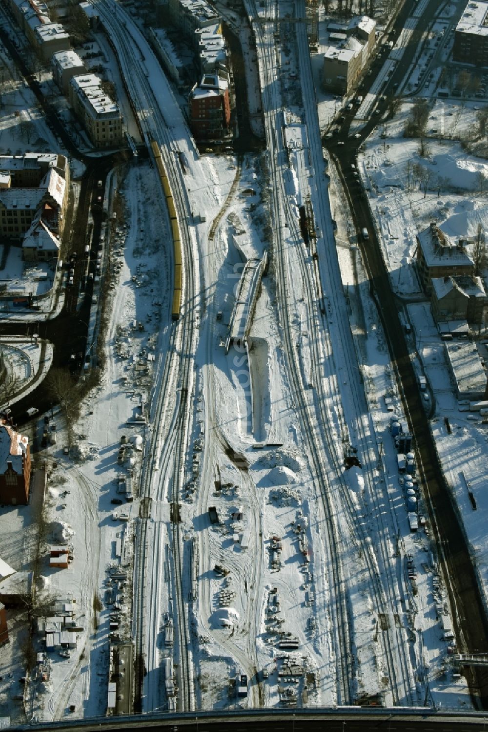 Berlin from the bird's eye view: Snow-covered railway tracks and construction site East of the train station Berlin Ostkreuz in Berlin in Germany