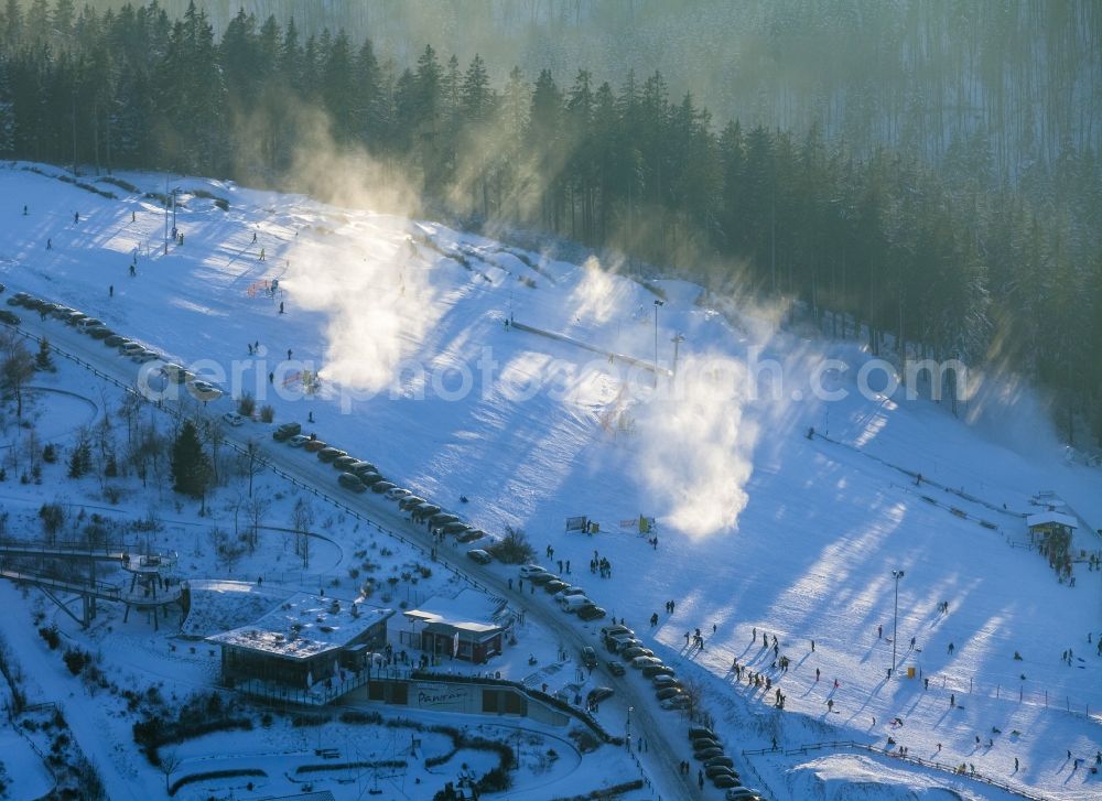 Winterberg from the bird's eye view: Snowy ski slopes and downhill skiing in the winter sports areas in Winterberg in North Rhine-Westphalia