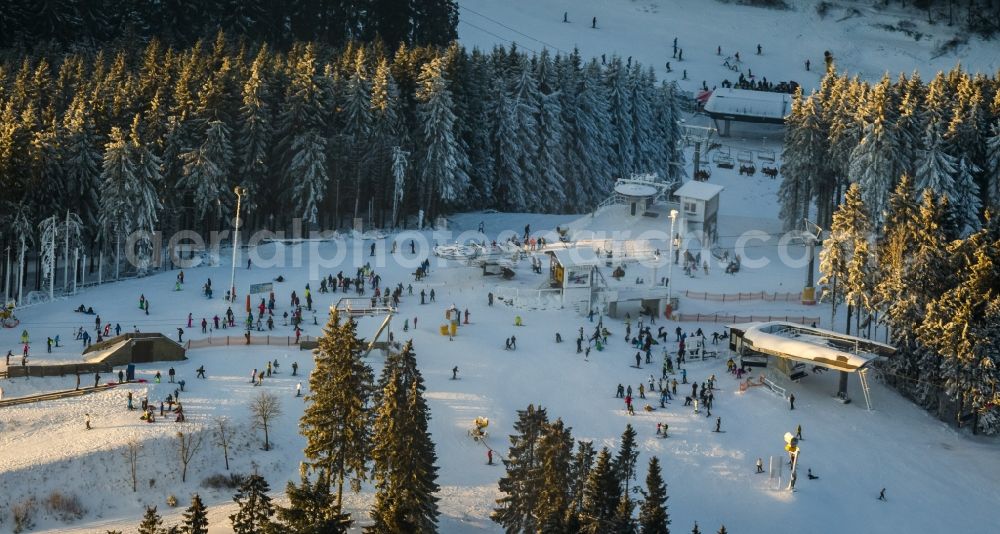 Aerial image Winterberg - Snowy ski slopes and downhill skiing in the winter sports areas in Winterberg in North Rhine-Westphalia