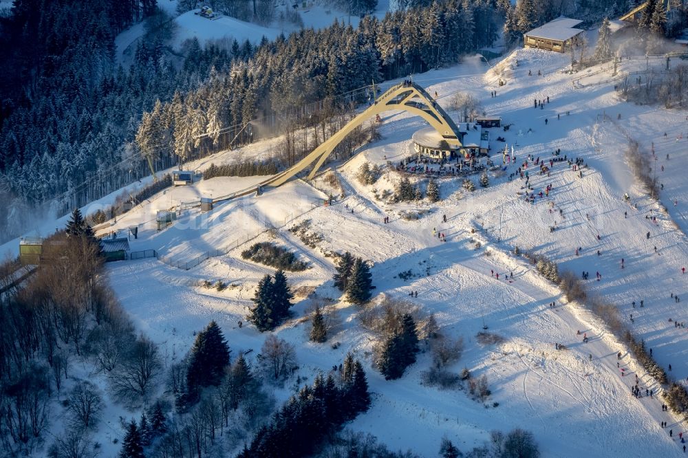 Winterberg from above - Snowy ski slopes and downhill skiing in the winter sports areas in Winterberg in North Rhine-Westphalia