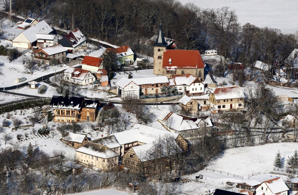 Wipfratal from above - Wintry snowy church building St. Cyriakus in Ettischleben in the state Thuringia