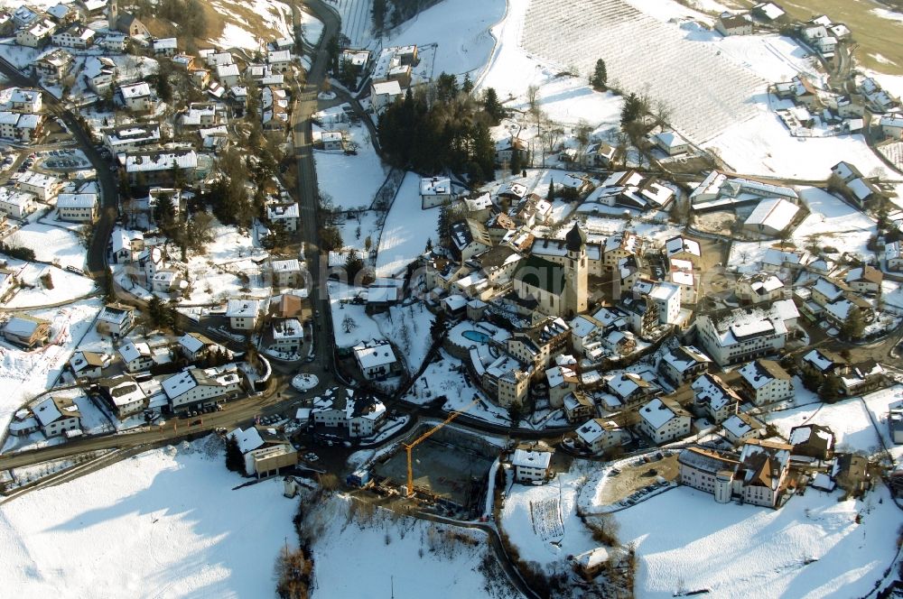 Völs am Schlern - Fié allo Sciliar from the bird's eye view: Wintry snowy church building in Voels am Schlern - Fie allo Sciliar in Trentino-Alto Adige, Italy