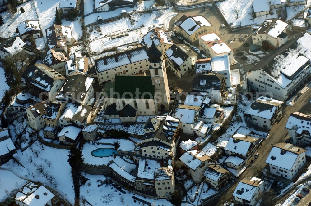 Völs am Schlern - Fié allo Sciliar from the bird's eye view: Wintry snowy church building in Voels am Schlern - Fie allo Sciliar in Trentino-Alto Adige, Italy