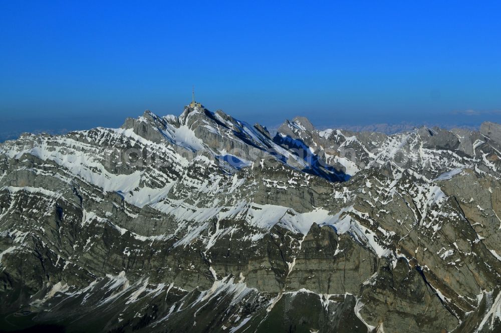 Aerial image Säntis - Snow veiled mountain range Santis - Mountain in the Appenzell Alps in Switzerland