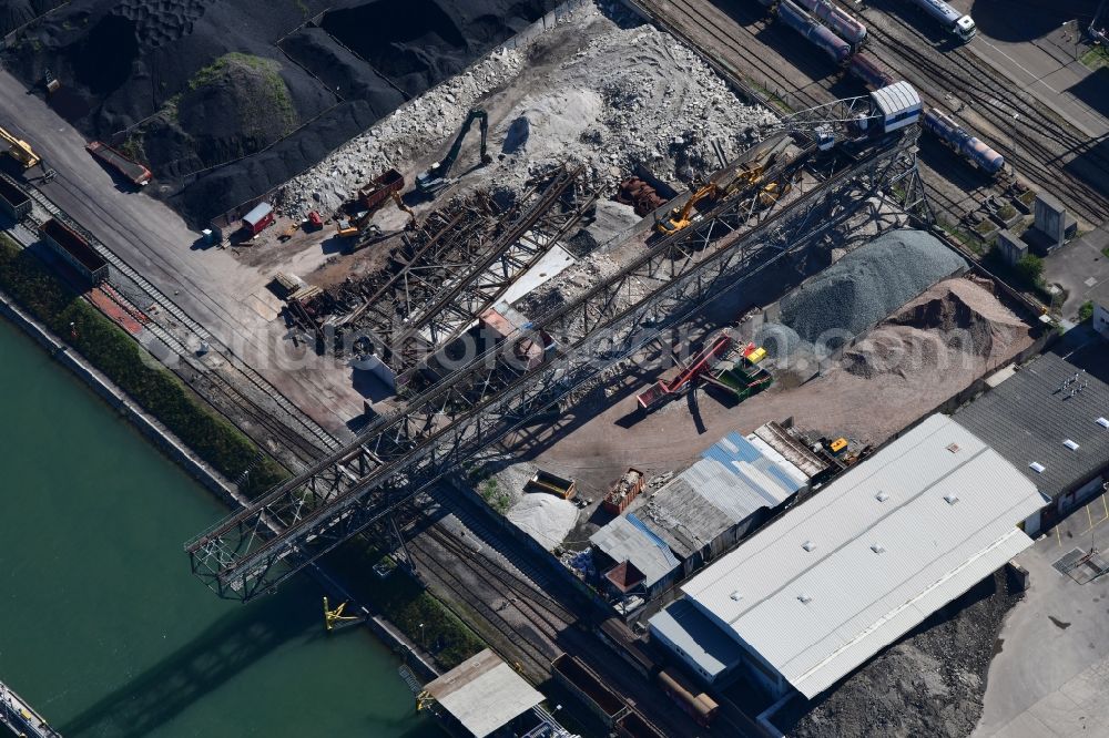 Birsfelden from above - Wharves and jetties marine inland waterway with loading of building materials, earth, gravel, stones or other materials in the inner harbor at the river Rhine in Birsfelden in the canton Basle-Landschaft, Switzerland