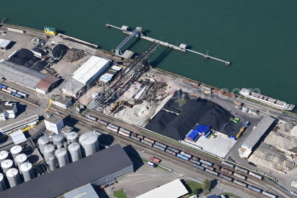 Aerial image Birsfelden - Wharves and jetties marine inland waterway with loading of building materials, earth, gravel, stones or other materials in the inner harbor at the river Rhine in Birsfelden in the canton Basle-Landschaft, Switzerland