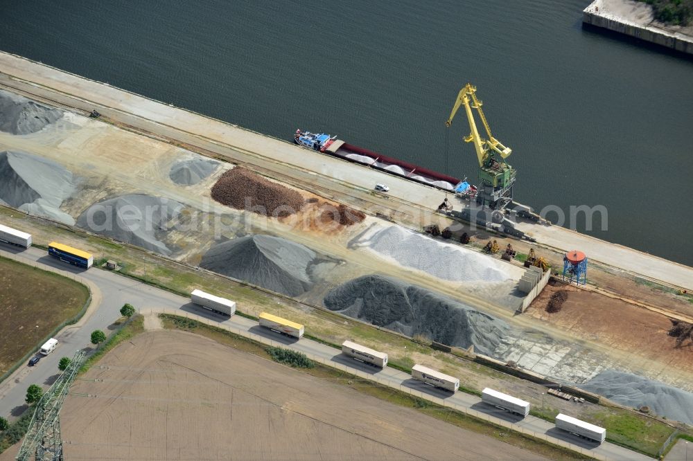 Lübeck from above - Wharves and jetties marine inland waterway with loading of building materials, earth, gravel, stones or other materials in the inner harbor in Luebeck in the state Schleswig-Holstein