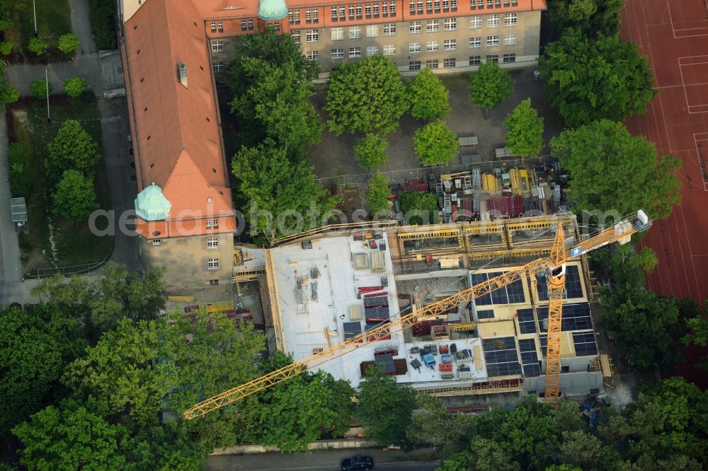 Berlin from above - School grounds, building complex and construction works at Arndt-Gymnasium Dahlem in the district of Steglitz-Zehlendorf in Berlin in Germany. A new building is being developed next to the historic main building with the red roof, small towqer and green dome