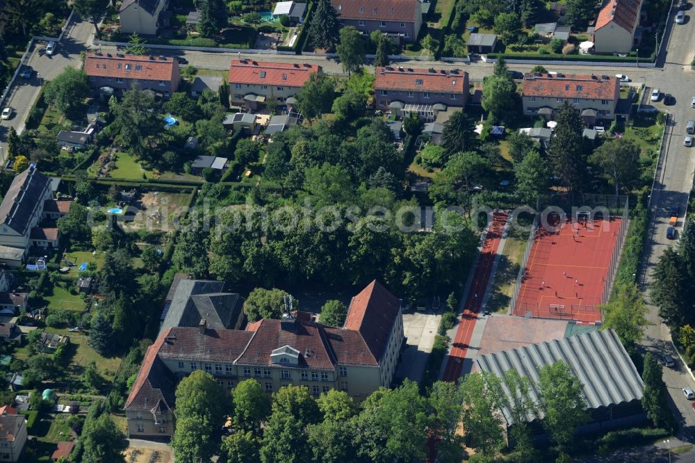 Berlin from above - School grounds and buildings of the Fritz-Kuehn-School in the Bohnsdorf part of the district of Treptow-Koepenick in Berlin in Germany. The integrated secondary school with its historic main building and sports facilities is located between trees and green spaces on Dahmestrasse