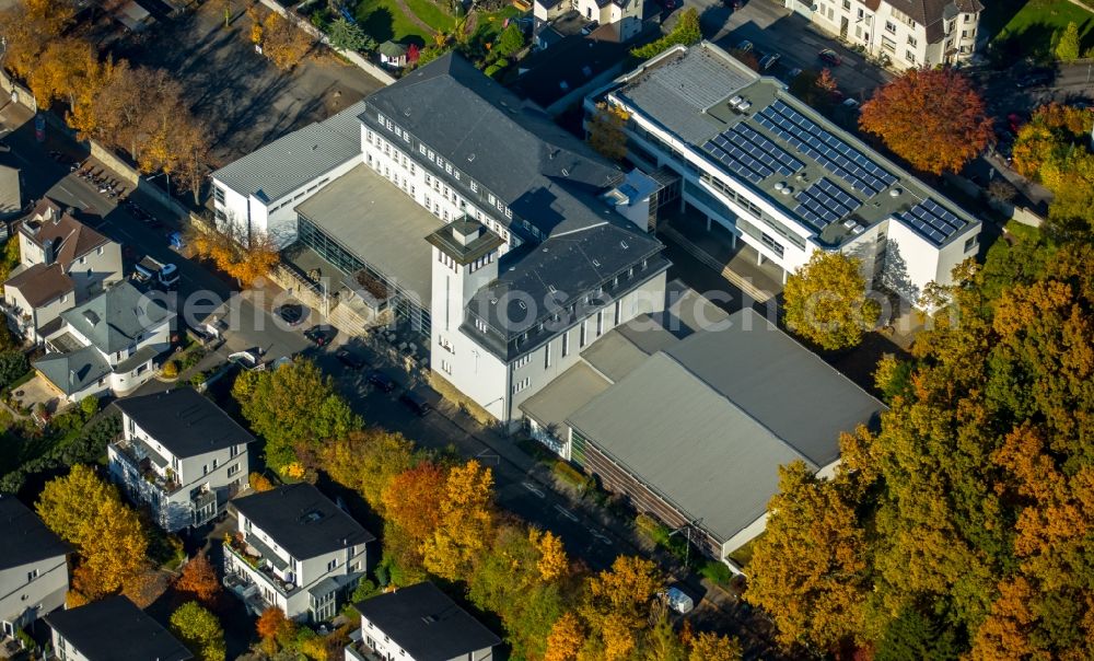 Aerial image Neheim - School grounds and buildings of the high school of Saint Ursula on Engelbertstrasse in Neheim in the state of North Rhine-Westphalia. The white building with the tower is located on an autumnal and colourful forest