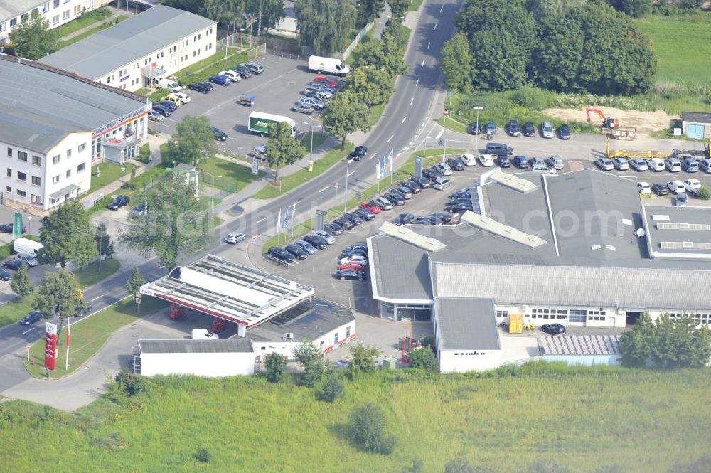 Bernau from the bird's eye view: Look at the Schwanebeck avenue in Bernau with the Star gasoline and the car dealership Zemke. In the background the meadows of the Panke river can be seen