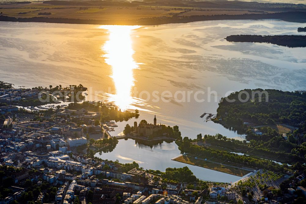 Schwerin from the bird's eye view: Domed towers of the Schwerin Castle and the Castle Church at the Castle Garden, the seat of the state parliament in the state capital of Mecklenburg-Western Pomerania at sunrise