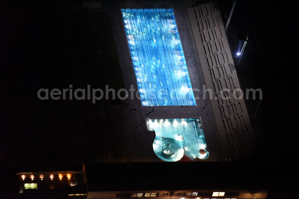 München from above - Night view Swimming pool of the Dante-Winter-Warmfreibad an der Postillonstrasse in Munich in the state Bavaria