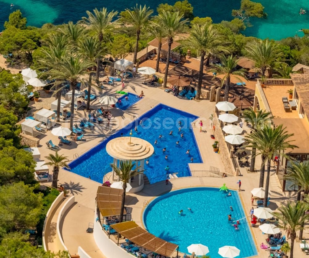 Aerial photograph Cala D'or - Refreshing swim in the blue pool - swimming pool of Hotel Robinson Cala Serena in Cala D'or in Balearic island of Mallorca, Spain