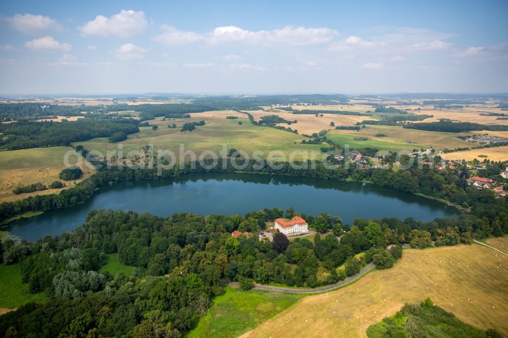 Schorssow from the bird's eye view: Lake Haussee with hotel Seeschloss Schorssow in Schorssow in the state Mecklenburg - Western Pomerania