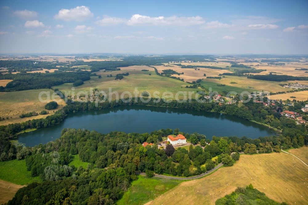 Schorssow from the bird's eye view: Lake Haussee with hotel Seeschloss Schorssow in Schorssow in the state Mecklenburg - Western Pomerania