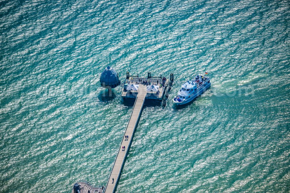 Grömitz from the bird's eye view: Pier with excursion boat on the sea coast of the Baltic Sea in Groemitz in the state of Schleswig-Holstein