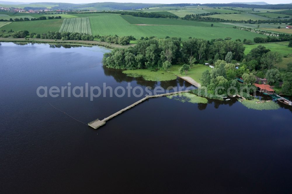 Seeburg from above - View of river banks and bridge with a lawn of Seeburger lake in Seeburg in Lower Saxony