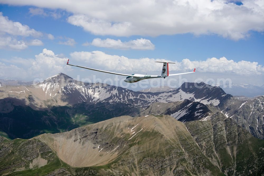 Orcières from the bird's eye view: Glider ASW 20 D-6538 in flight over the rugged peak of the mountain Grande Autanedes in the national park Ecrins in Provence-Alpes-Cote d'Azur, France