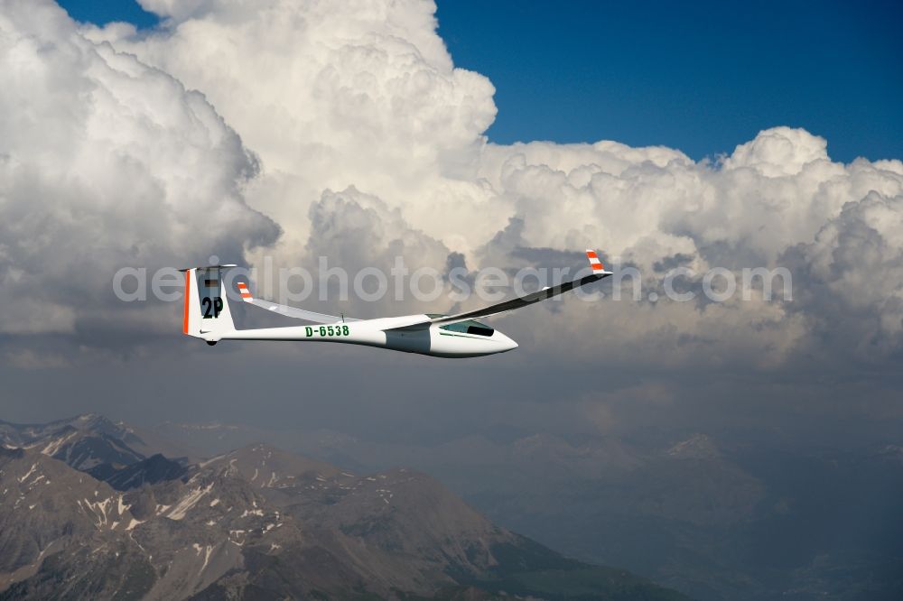 Aerial photograph Saint-Léger-les-Mélèzes - Glider ASW 20 D-6538 in flight over the rugged peak of the mountain Grande Autanedes in the national park Ecrins in Provence-Alpes-Cote d'Azur, France