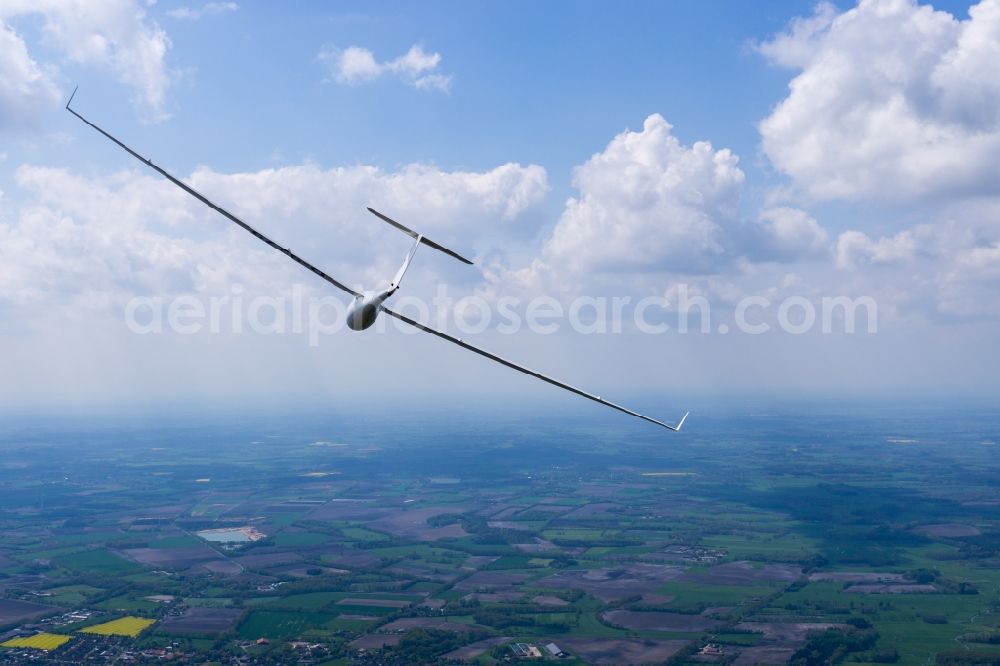 Heinbockel from the bird's eye view: Glider ASW 27 D-9279 in flight over a luminous rape field near Heinbockel in the state of Lower Saxony, Germany