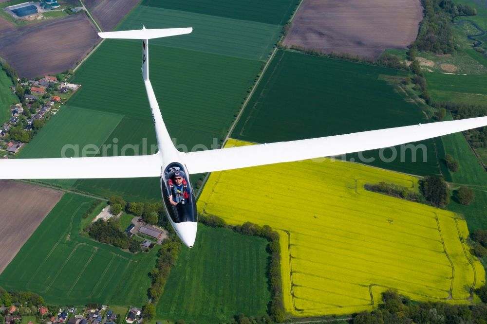 Aerial photograph Fredenbeck - Glider ASW 27 D-9279 in flight over a luminous rape field near Fredenbeck in the state of Lower Saxony, Germany