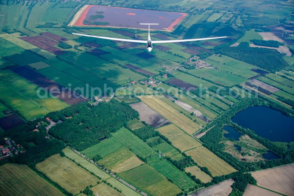 Stade from above - High performance glider ASW 20 in flight over the red mud dump near Stade-Buetzfleth in Lower Saxony, Germany. An aluminum production waste product is deposited here