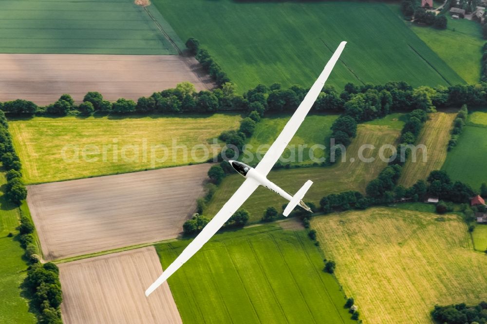 Stade from above - High performance glider ASW 20 in flight over the fields near Stade in Lower Saxony, Germany. An aluminum production waste product is deposited here