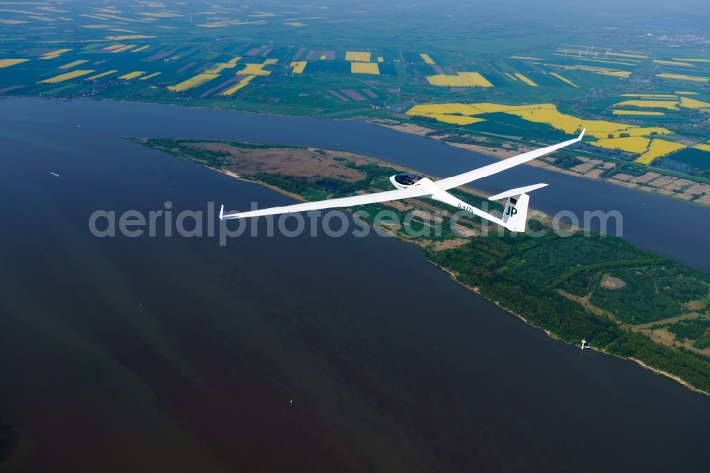 Seestermühe from above - Glider and sport aircraft ASW 27 flying over the airspace in Seestermuehe in the state Schleswig-Holstein, Germany