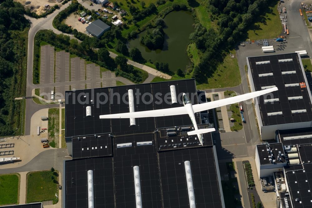 Stade from above - Glider ASW 20 flying above the factory and the production halls of Airbus in Stade in the state Lower Saxony, Germany