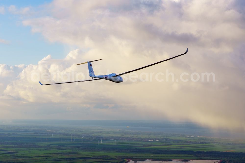 Aerial image Deinste - Glider and sport aircraft LS-4 D-4103 flying in front of rain clouds over the airspace of Deinste in the state Lower Saxony, Germany