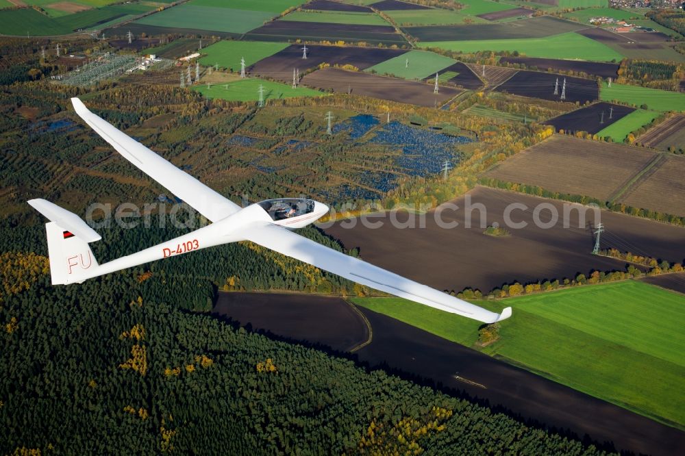 Aerial image Deinste - Glider and sport aircraft LS-4 D-4103 flying over the airspace of the Feerner Moor and a electric transformer station close to Dollern in the state Lower Saxony, Germany