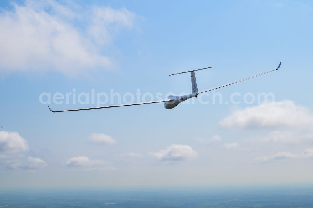 Himmelpforten from above - Glider and sport aircraft LS-4 D-4103 flying below cumulus clouds over the airspace of Himmelpforten in the state Lower Saxony, Germany